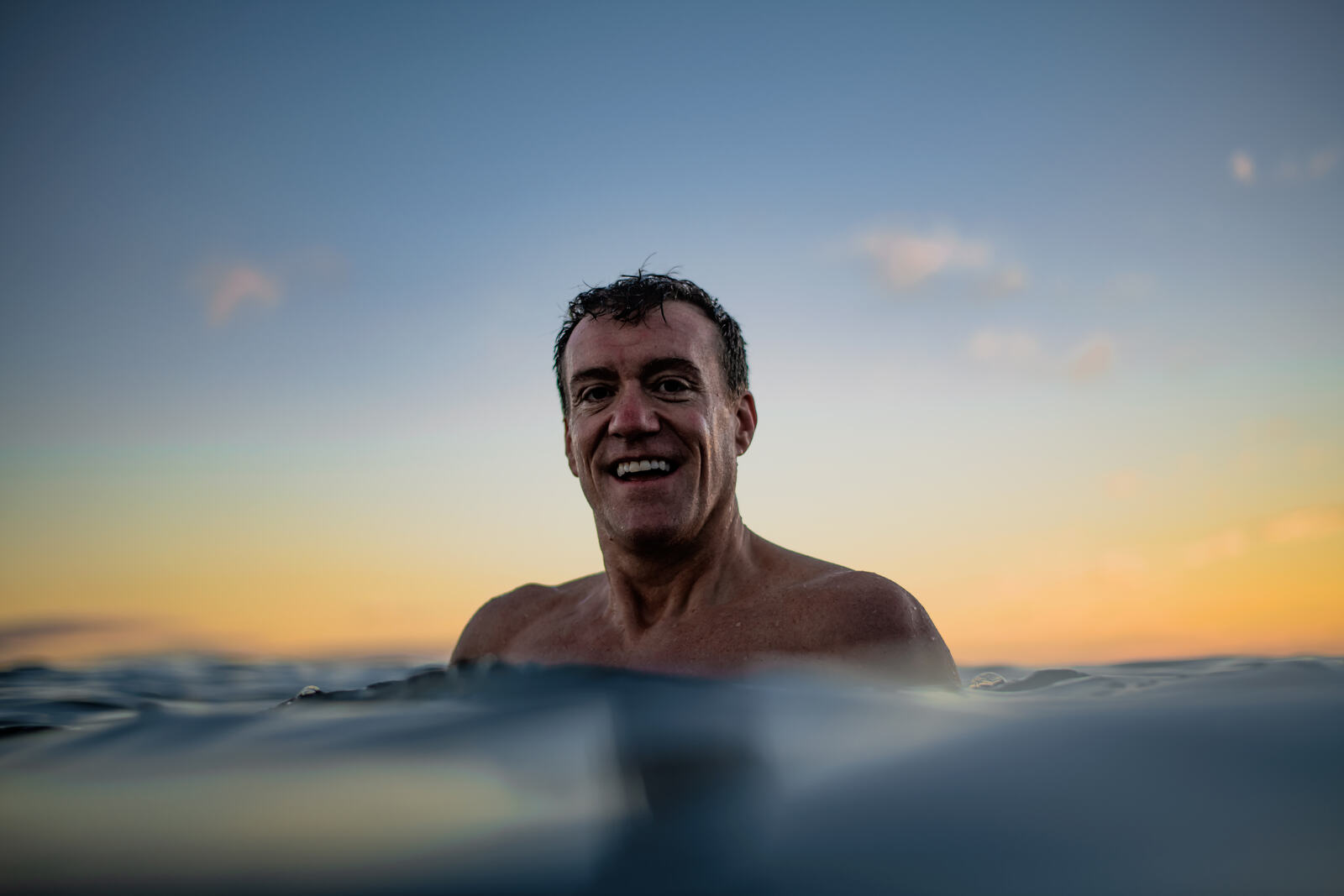 Andy Ramage swimming in the sea at sunrise
